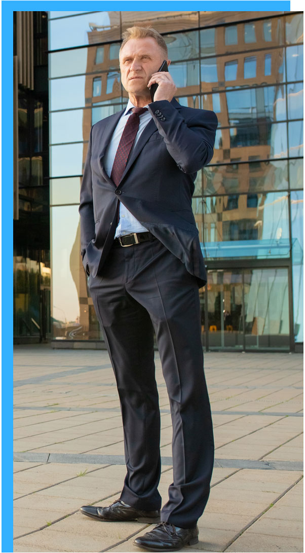 a man is talking on phone call wearing a suit